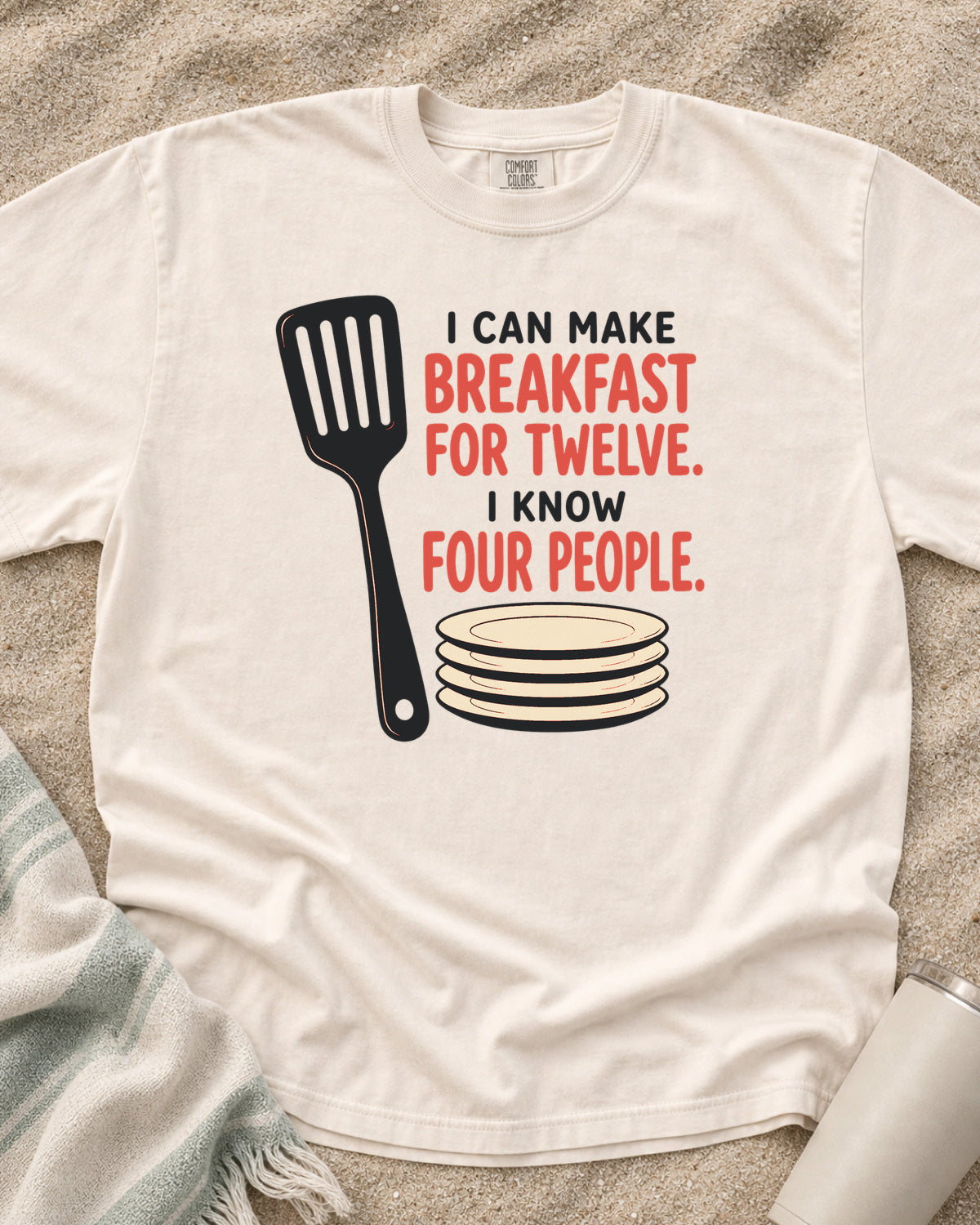 Ivory garment-dyed tee with I Can Make Breakfast for Twelve griddle graphic.