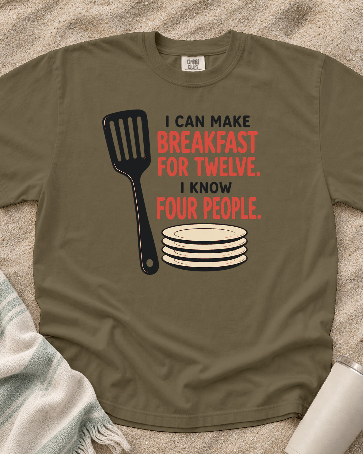 Khaki garment-dyed tee with I Can Make Breakfast for Twelve griddle graphic.