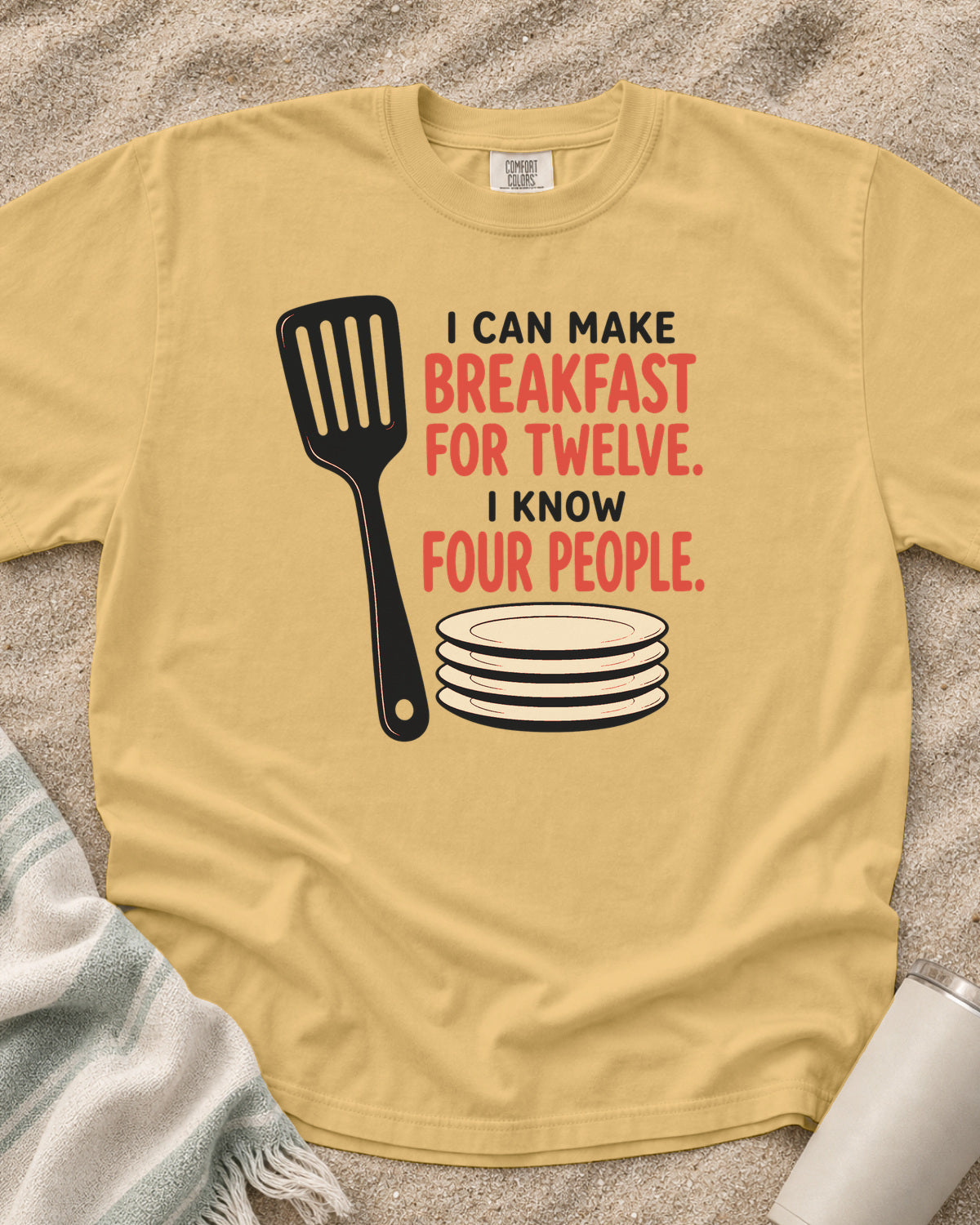 Mustard garment-dyed tee with I Can Make Breakfast for Twelve griddle graphic.