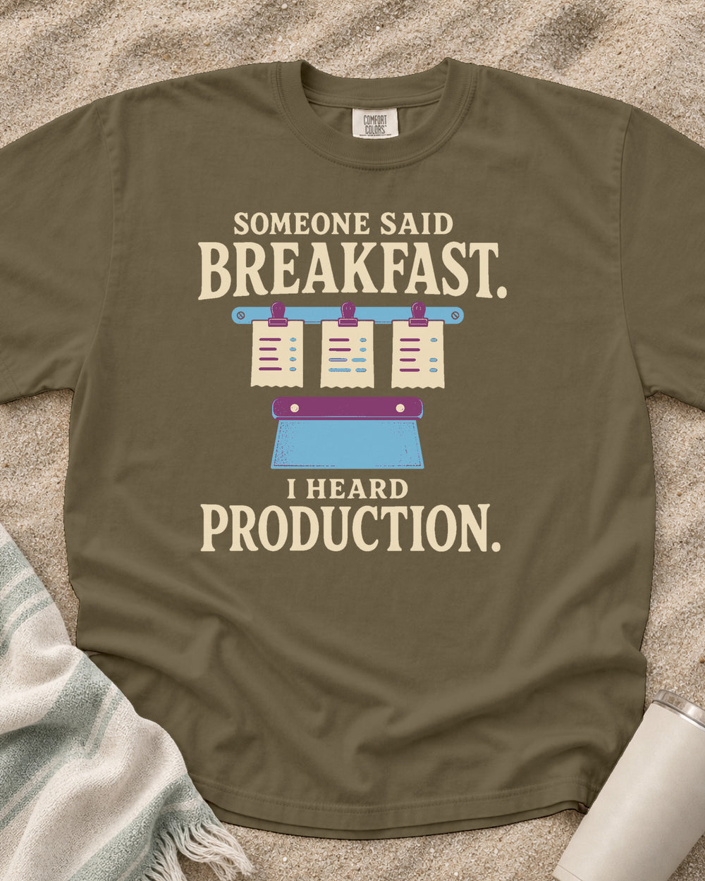 Khaki garment-dyed tee with Someone Said Breakfast I Heard Production graphic.