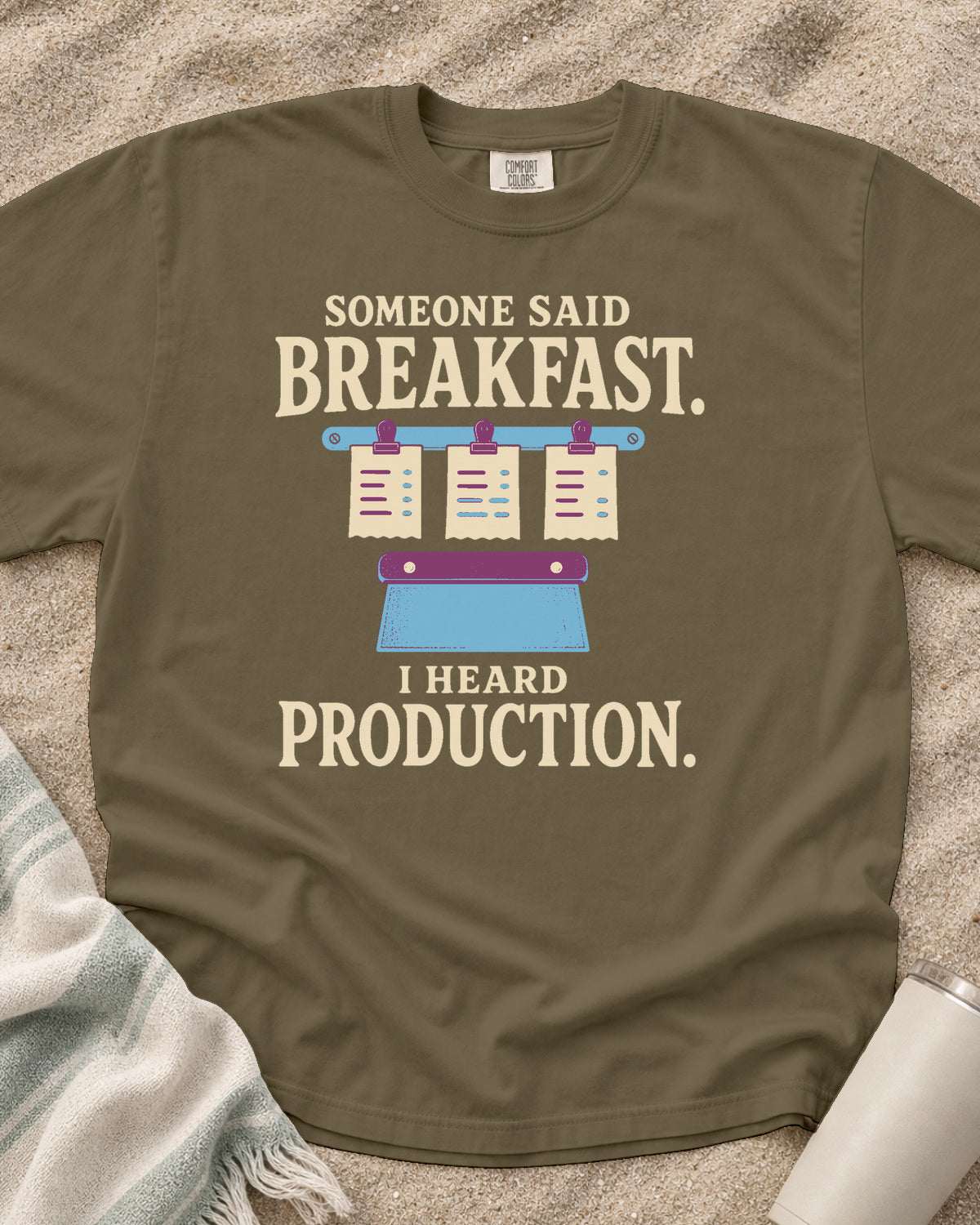 Khaki garment-dyed tee with Someone Said Breakfast I Heard Production graphic.