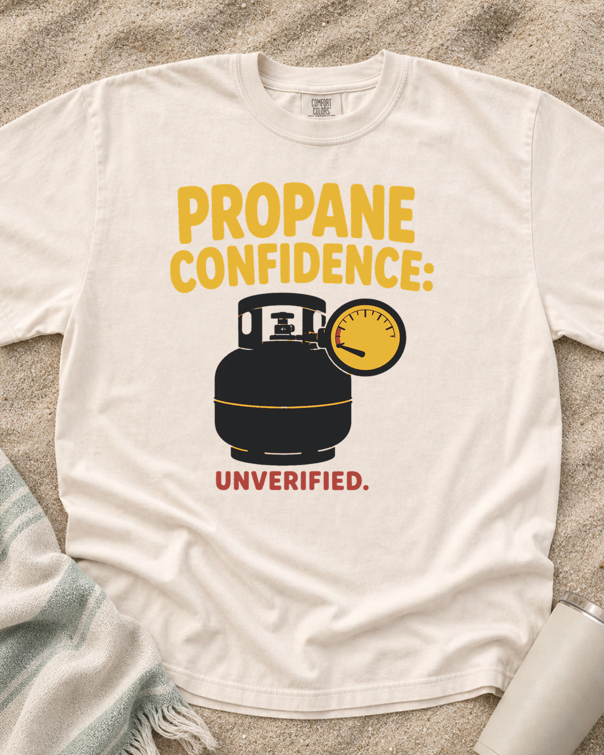 Ivory garment-dyed tee with Propane Confidence Unverified griddle graphic.