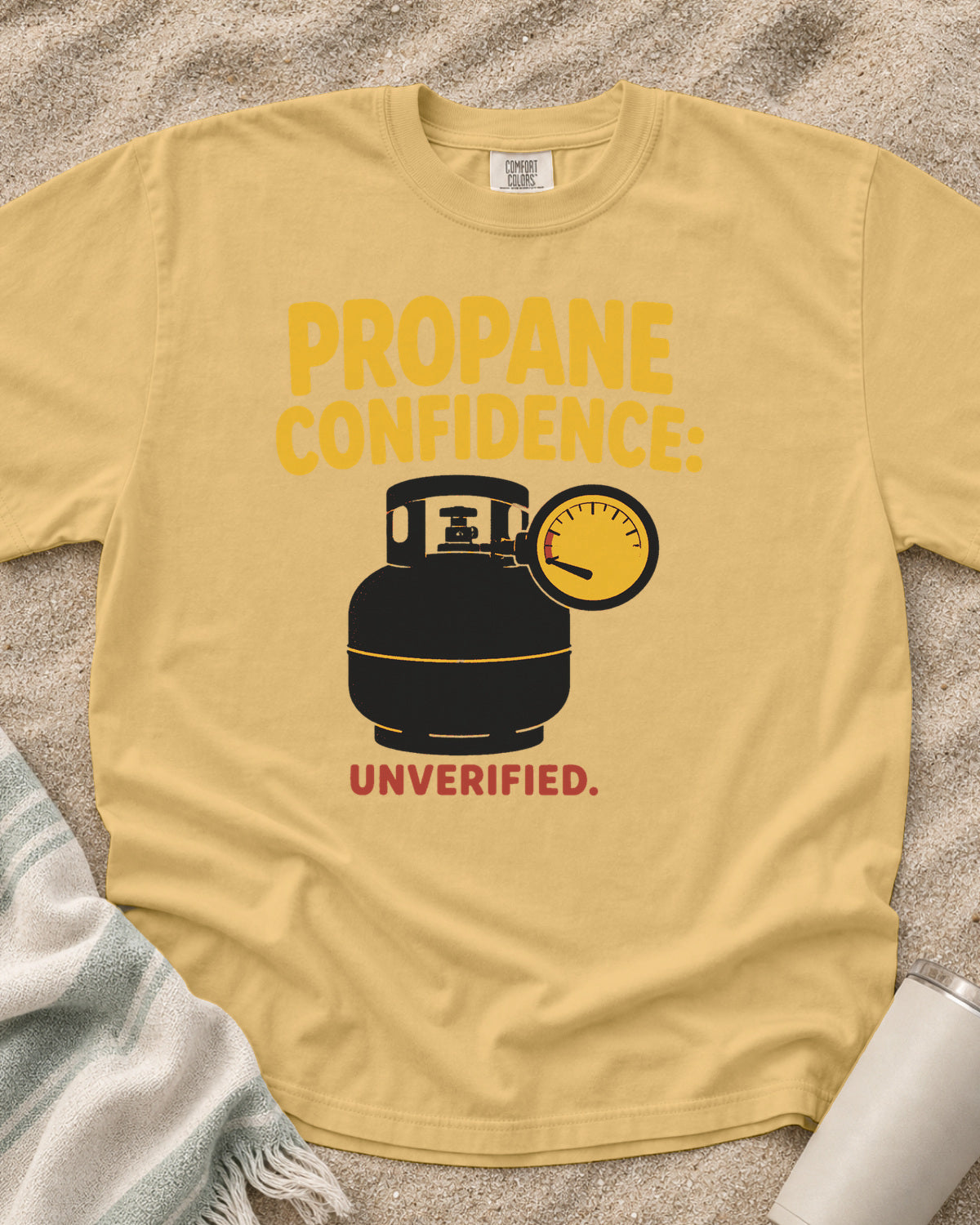 Mustard garment-dyed tee with Propane Confidence Unverified griddle graphic.