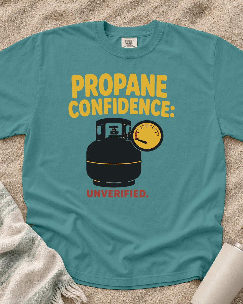 Seafoam garment-dyed tee with Propane Confidence Unverified griddle graphic.