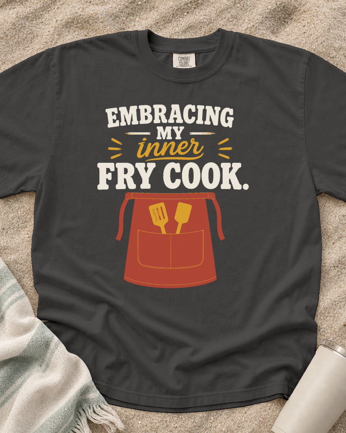 Pepper garment-dyed tee with Embracing My Inner Fry Cook griddle graphic.