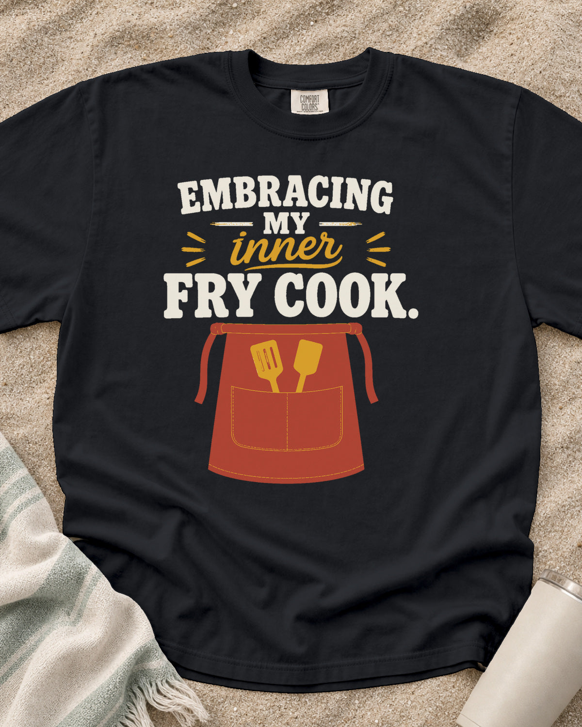 Graphite garment-dyed tee with Embracing My Inner Fry Cook griddle graphic.