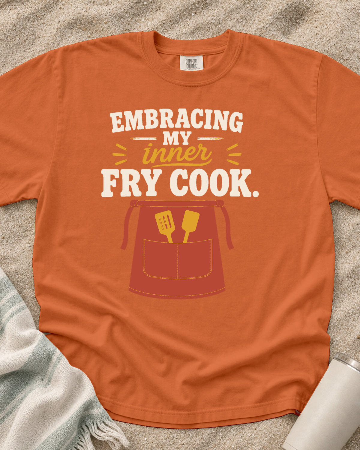 Burnt Orange garment-dyed tee with Embracing My Inner Fry Cook griddle graphic.
