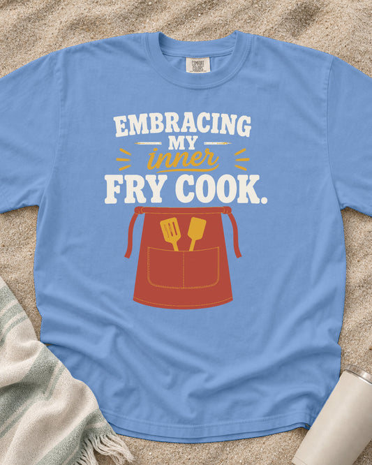 Washed Denim garment-dyed tee with Embracing My Inner Fry Cook griddle graphic.