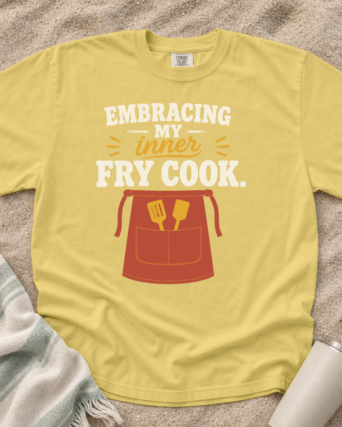 Butter garment-dyed tee with Embracing My Inner Fry Cook griddle graphic.