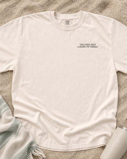 Ivory Comfort Colors 1717 tee with The First Mile Clears Its Throat graphic.