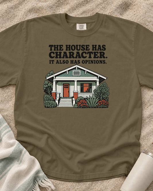 Khaki Comfort Colors 1717 tee with The House Has Character. It Also Has Opinions graphic.